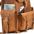 This tan brown leather backpack has three pockets with pockets behind them.