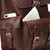 This red brown leather backpack has pockets behind the pockets.
