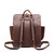 This is a red brown leather backpack with a pocket on the back side.