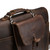 This is a dark brown leather satchel that is thin from the front side upclose.