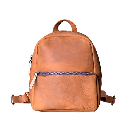 This tan brown women's leather backpack is showing the front.