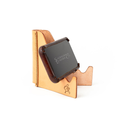This leather phone stand is holding an iPhone at an angle for conference calls and for schooling videos.