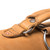 This is the top view of the hardware on a tan brown rounded leather satchel.