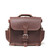 This is the front view of a reddish brown rounded leather satchel.