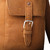 16 inch leather drawstring backpack in tobacco close up view of the pocket