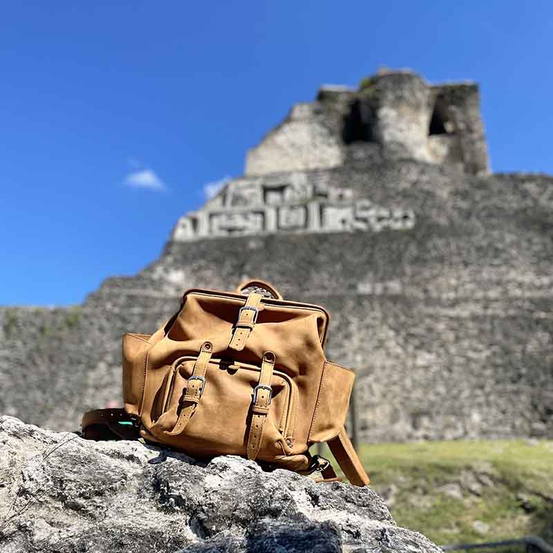 The big mouth full grain leather backpack is made with tough, water resistant, and stain resistant material, as well as a durable metal frame closure. It also has multiple pockets for storage, including two side pockets and two interior back pockets.