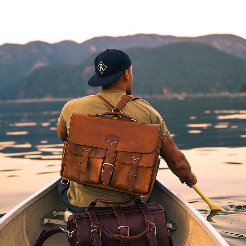 The leather briefcase has a detachable, adjustable shoulder strap and d-rings on the bottom for versatile carrying.