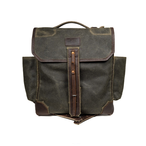 Front of the canvas backpack with the flap shut. Has 2 side pockets and a handle for easy carry. Made by Saddleback