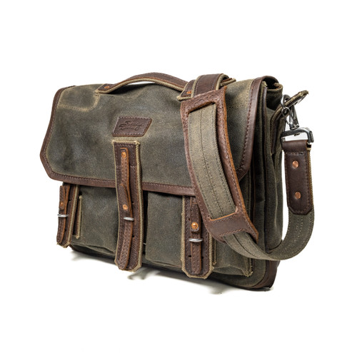 Side view of the Canvas Messenger bag with a shoulder strap, handle, and buckle to keep the bag closed. Made by Saddleback