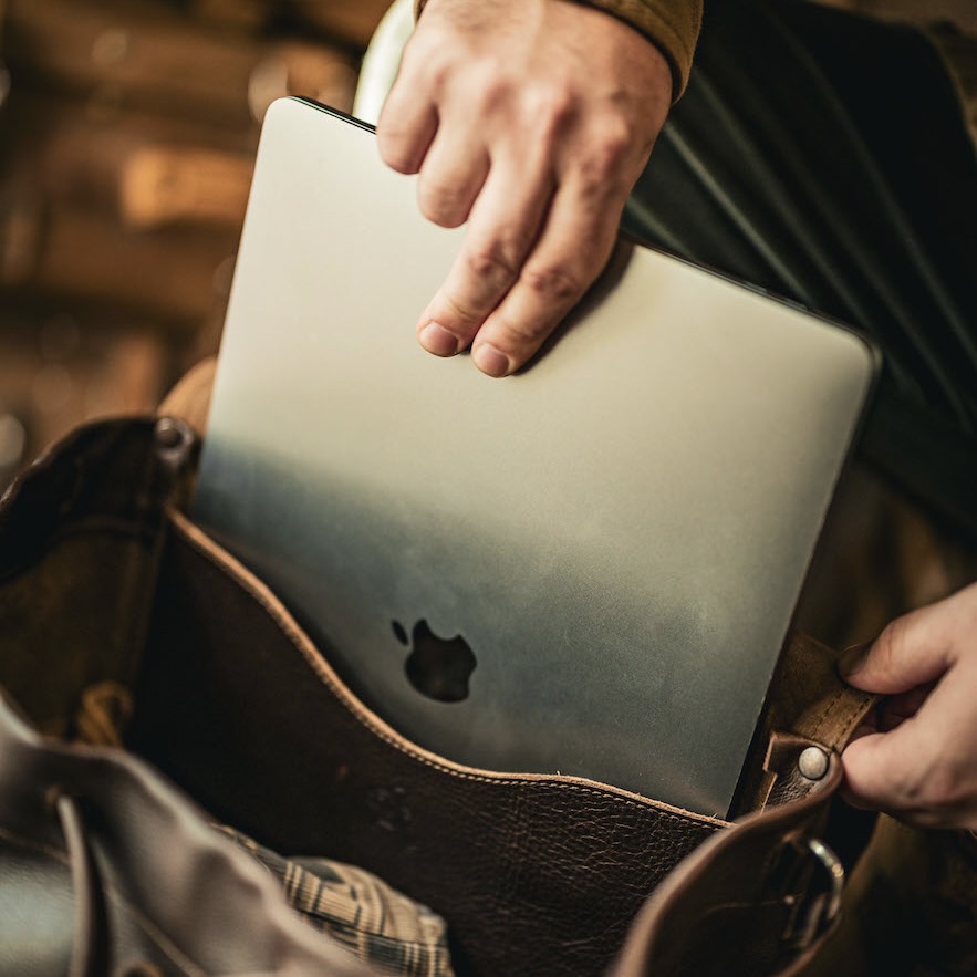 This leather backpack has a built-in laptop sleeve to fit a 16" laptop.