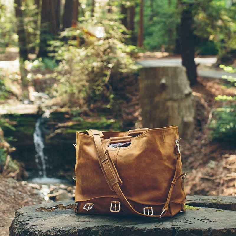 This leather duffle bag is popular for overnight travel because it is versatile and has no breakable parts.